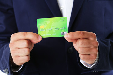 Businessman holding credit card,  close-up