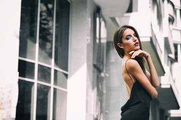 Beautiful young girl posing on city street