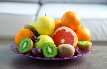 Fototapeta na wymiar Fresh fruits on table in living room, close up