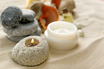 Fototapeta na wymiar Stack of spa stones on sand background
