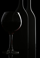 Naklejka na ściany i meble Bottle and glass of wine isolated on black
