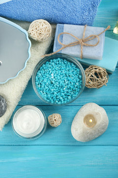 Spa stones and spa treatments on color wooden background