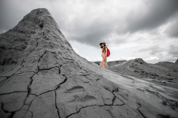 Female traveler walking near mud volcanoes