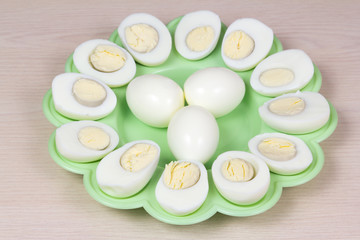Boiled chicken eggs on a green plate