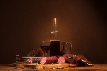Still life with wine and sausage