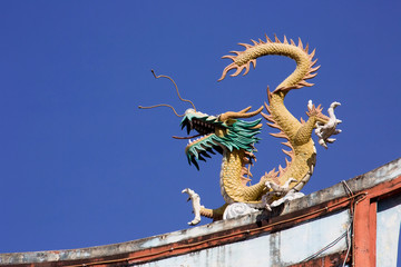 Fototapeta na wymiar Chinese dragon on the roof of a Buddhist temple, Manado, Sulawesi, Indonesia