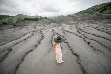 Female traveler near mud volcanoes