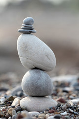 Fototapeta na wymiar pile of balanced round stones on the beach