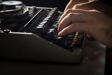Human hands typing with typewriter