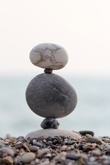 Fototapeta na wymiar pile of balanced round stones on the beach