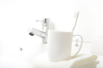 洗面台に置かれた歯ブラシとコップ