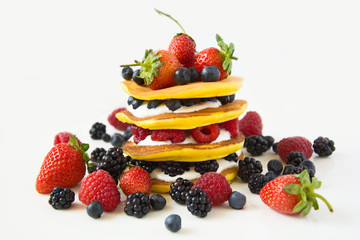 Homemade pancakes with berries on white plate