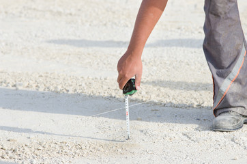 Worker with measuring tape
