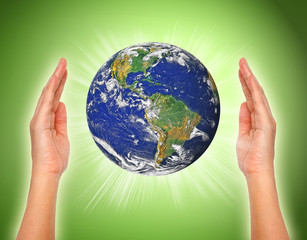 woman's hand holding the earth