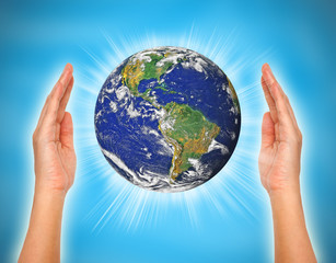 woman's hand holding the earth