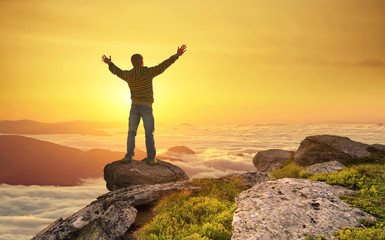 Fototapeta premium Silhouette of a champion on mountain peak. Active life concept..