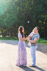Fototapeta premium Happy Young Family Walking In The Park.