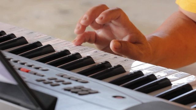 closeup hands playing keyboard