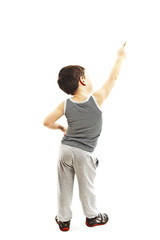 Back view of little boy points at wall. Rear view. Isolated on white background 
