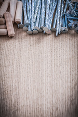 Group of wooden dowels and construction nails copy space image