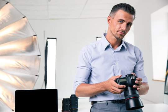 Portrait of a handsome man holding camera