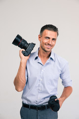 Handsome photographer holding camera