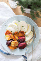 Starter of italian mozzarella cheese and grilled pluots, apricots and flat peaches with olive oil and thyme