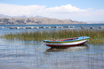 Colorful boat on the scenic coast of Titicaca lake in Bolivia, South America