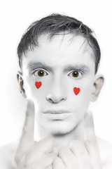 man with white makeup and red hearts on face