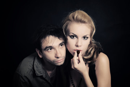 Young Man And Woman With Chocolate Candies