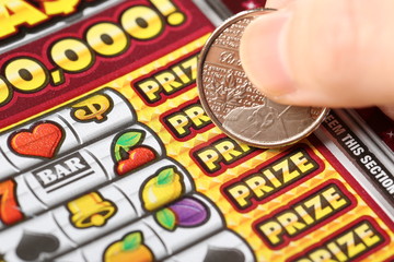 Close up woman scratching lottery tickets.