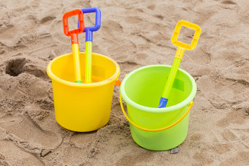 Fototapeta na wymiar kid's toys for playing sand bucket and shovel in playground