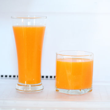 glass of fresh orange juice in refrigerator