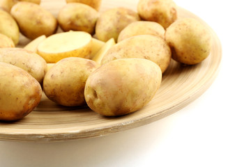Fototapeta na wymiar Young potatoes on plate close up