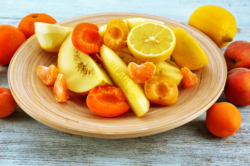 Heap of fresh fruits on wooden table close up