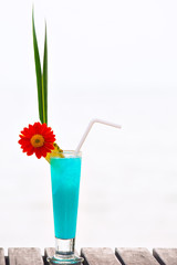 Blue Lagoon cocktail on the table at tropical beach resort