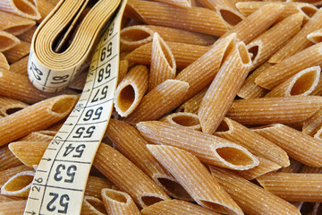 Dietetic whole wheat italian pasta penne whit tape meter