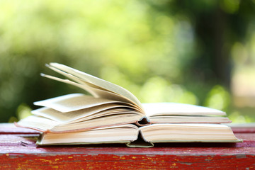 Stack of books outdoors, on blurred background