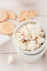 chunks of cheese with sundried tomatoes, herbs and spices