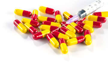 Yellow with red capsules and syringe, medication cure