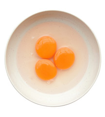 Egg yolk and white in a bowl isolated on white (clipping path)