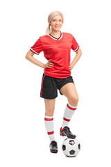 Female soccer player posing on white background