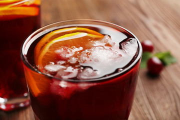 Glasses of cherry juice on wooden table, closeup