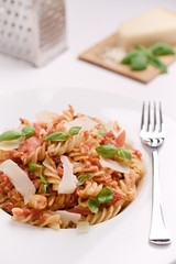 Italian homemade pasta with tomato sauce, basil and parmesan cheese. Concept of everyday dining.