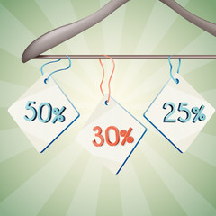 Sales tags with 25, 30 abd 50 percents discount tied on with the ribbon