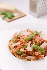 Italian homemade pasta with tomato sauce, basil and parmesan cheese. Concept of everyday dining.