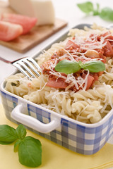 Italian homemade pasta with tomato sauce, basil and parmesan cheese. Concept of everyday dining.