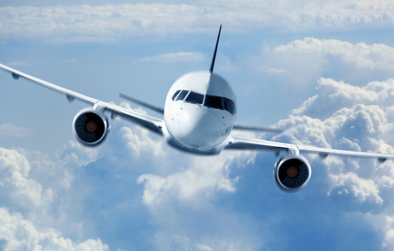 Fototapeta Passenger Airliner flying in the clouds