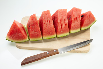Watermelon set on chopping block with knife