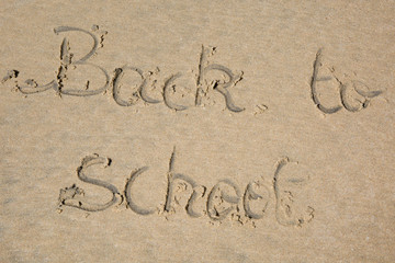Back to school written in sand
